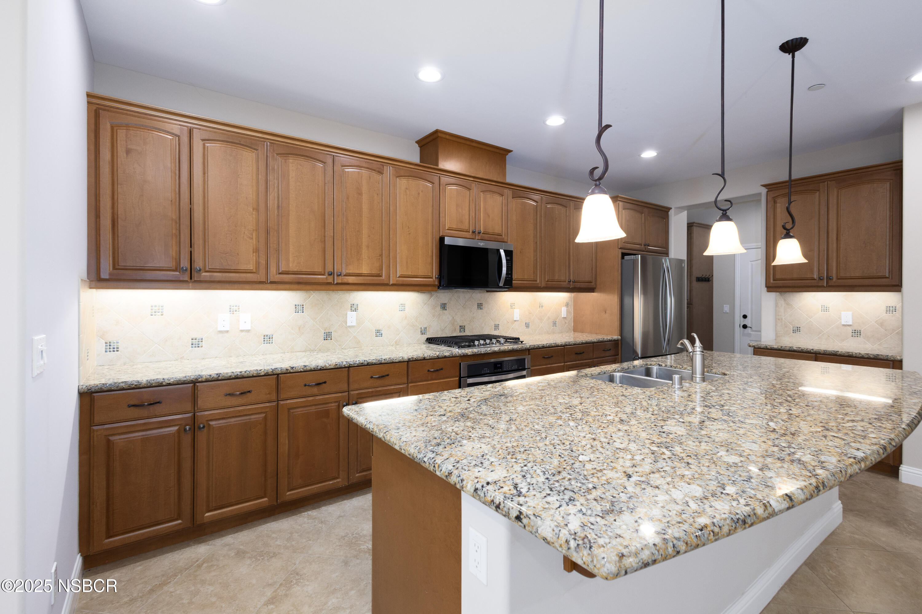 775 Mahogany Street Santa Maria, CA 93455 - Photo 3 of 34 a kitchen with a stove a sink and a refrigerator