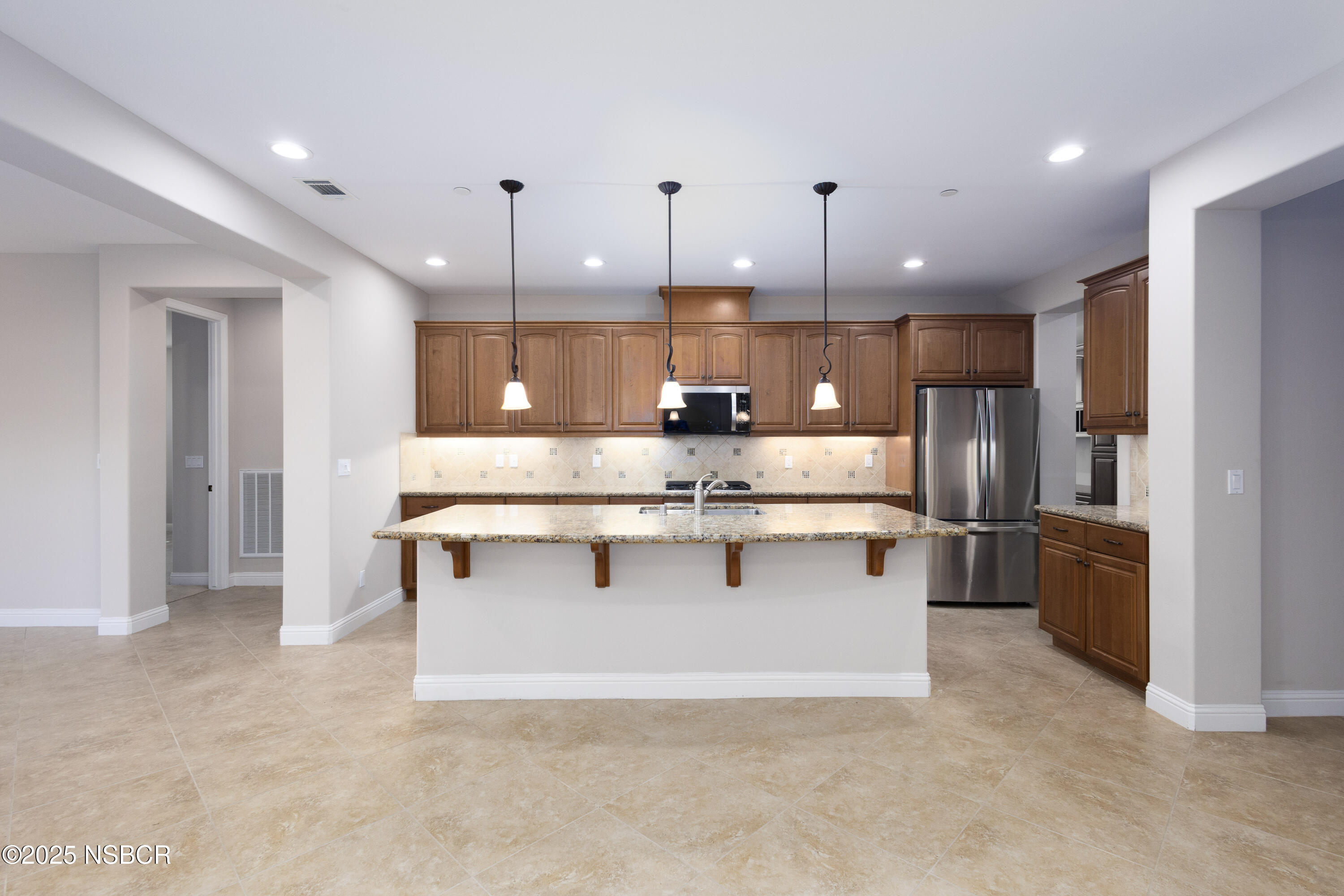 775 Mahogany Street Santa Maria, CA 93455 - Photo 4 of 34 a large kitchen with stainless steel appliances kitchen island a large counter space a sink and a refrigerator
