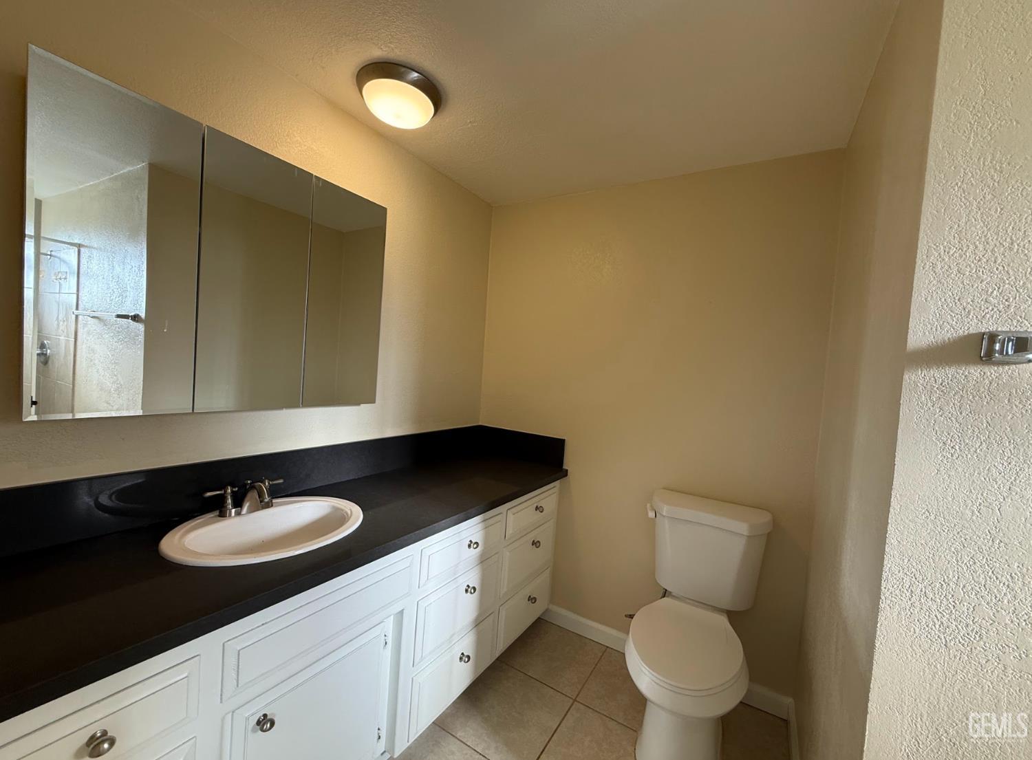 Undisclosed Address Ridgecrest, CA 93555 - Photo 26 of 45 a bathroom with a granite countertop sink a toilet and a mirror