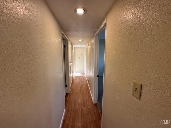 a kitchen with a refrigerator sink and cabinets
