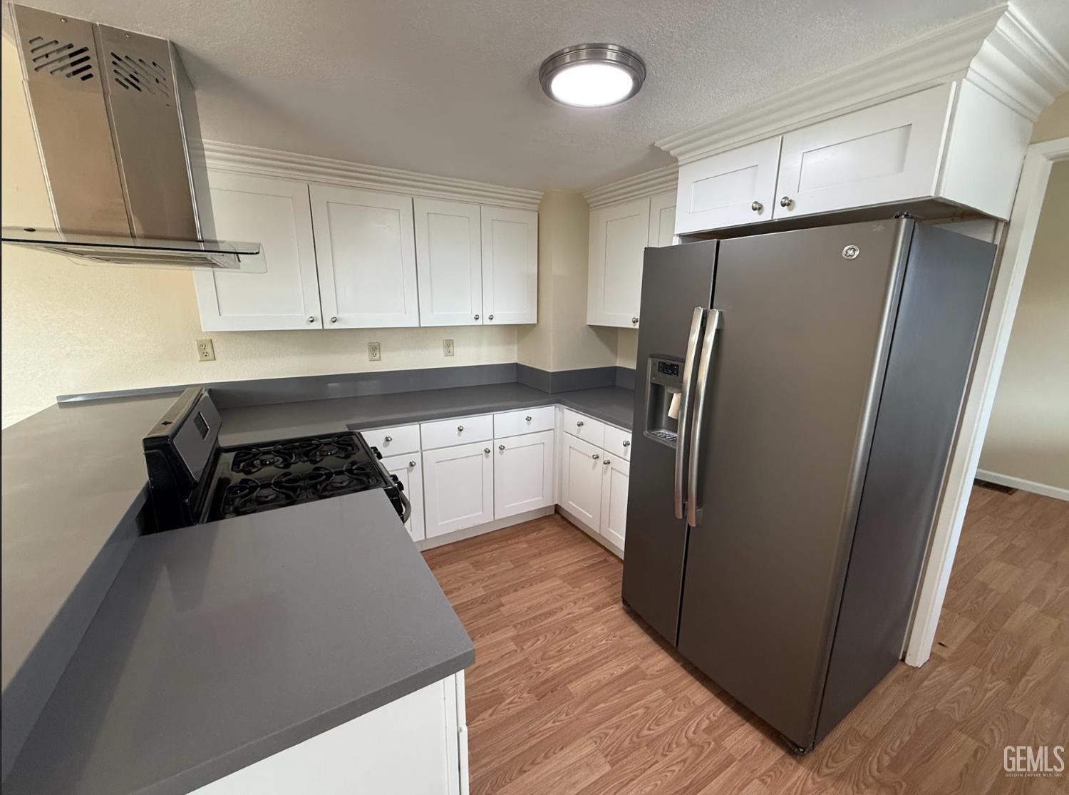 Undisclosed Address Ridgecrest, CA 93555 - Photo 37 of 45 a kitchen with a refrigerator sink and cabinets