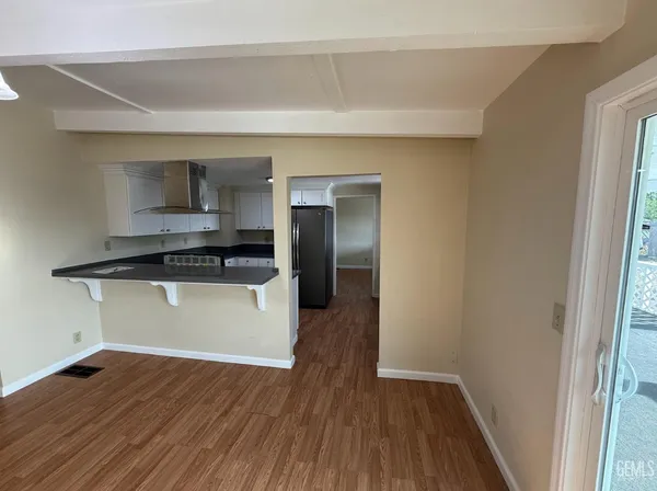 an empty room with wooden floor and fireplace
