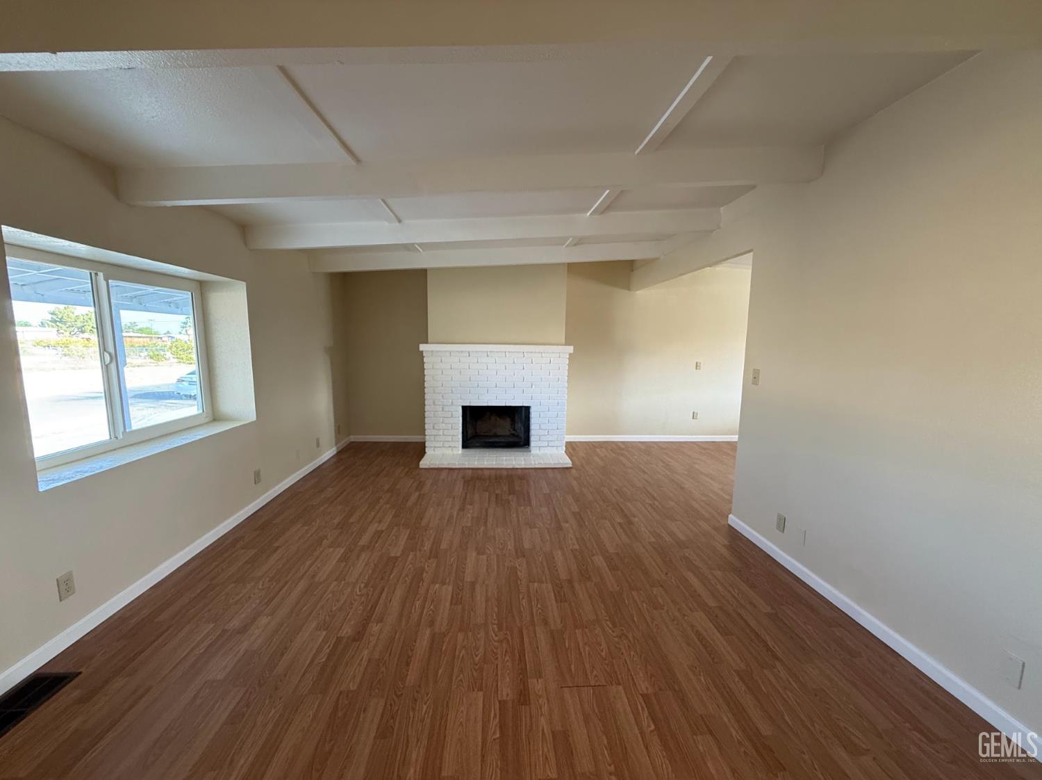 Undisclosed Address Ridgecrest, CA 93555 - Photo 43 of 45 an empty room with wooden floor and fireplace