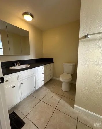 a kitchen with a sink and a toilet