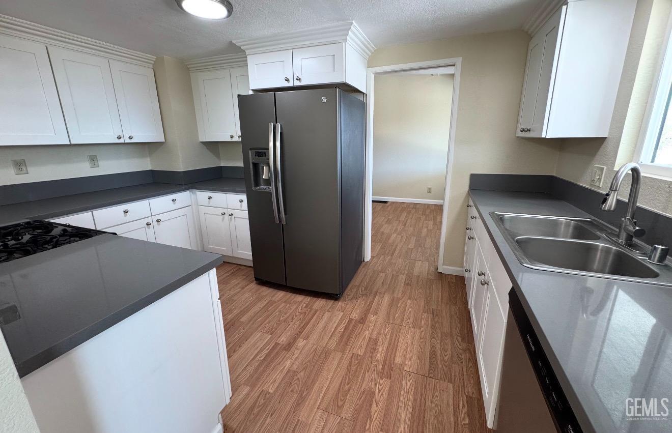 Undisclosed Address Ridgecrest, CA 93555 - Photo 10 of 45 a kitchen with a refrigerator sink and cabinets