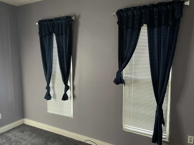 a balcony with wooden floor and an umbrella