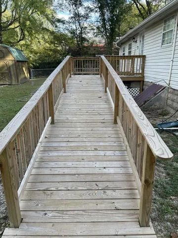 a view of a house with a wooden fence