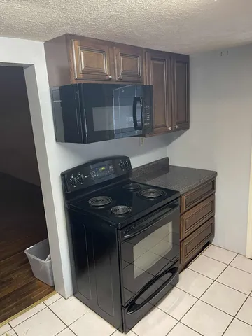 a stove top oven sitting inside of a kitchen