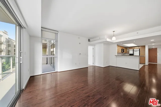 a view of a patio with couches table and chairs and potted plants