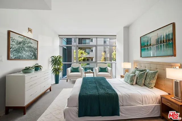 a living room with furniture and a floor to ceiling window