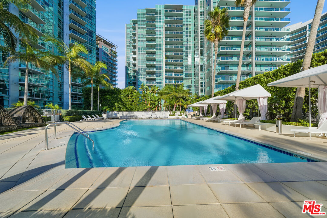 13700 Marina Pointe Drive, Unit 318 Marina del Rey, CA 90292 - Photo 54 of 75 a swimming pool with outdoor seating and yard