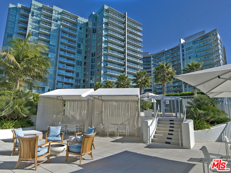 13700 Marina Pointe Drive, Unit 318 Marina del Rey, CA 90292 - Photo 57 of 75 a view of a patio with table and chairs and potted plants