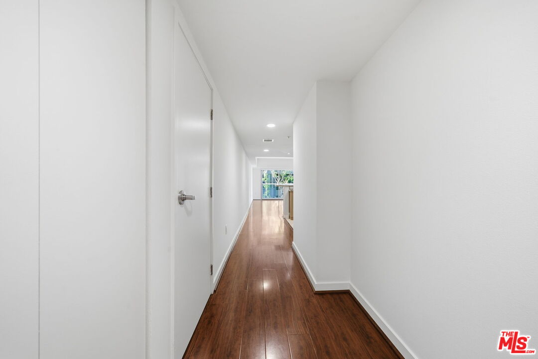13700 Marina Pointe Drive, Unit 318 Marina del Rey, CA 90292 - Photo 8 of 75 a view of a hallway with wooden floor
