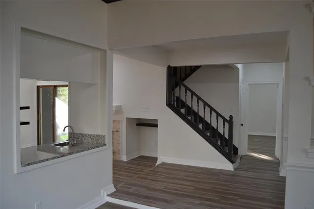 a view of entryway and hall with wooden floor