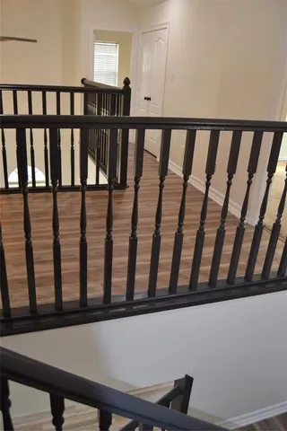 a view of staircase with railing and a window