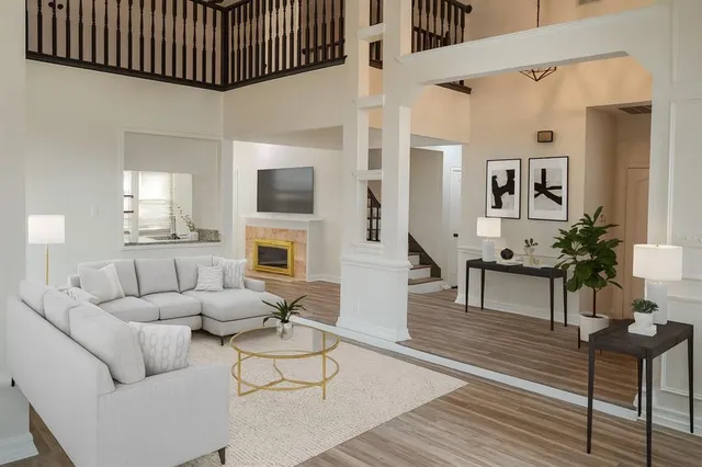 a living room with furniture a fireplace and a flat screen tv