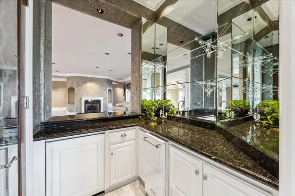 a view of a livingroom with a flat screen tv wooden floor and a fireplace