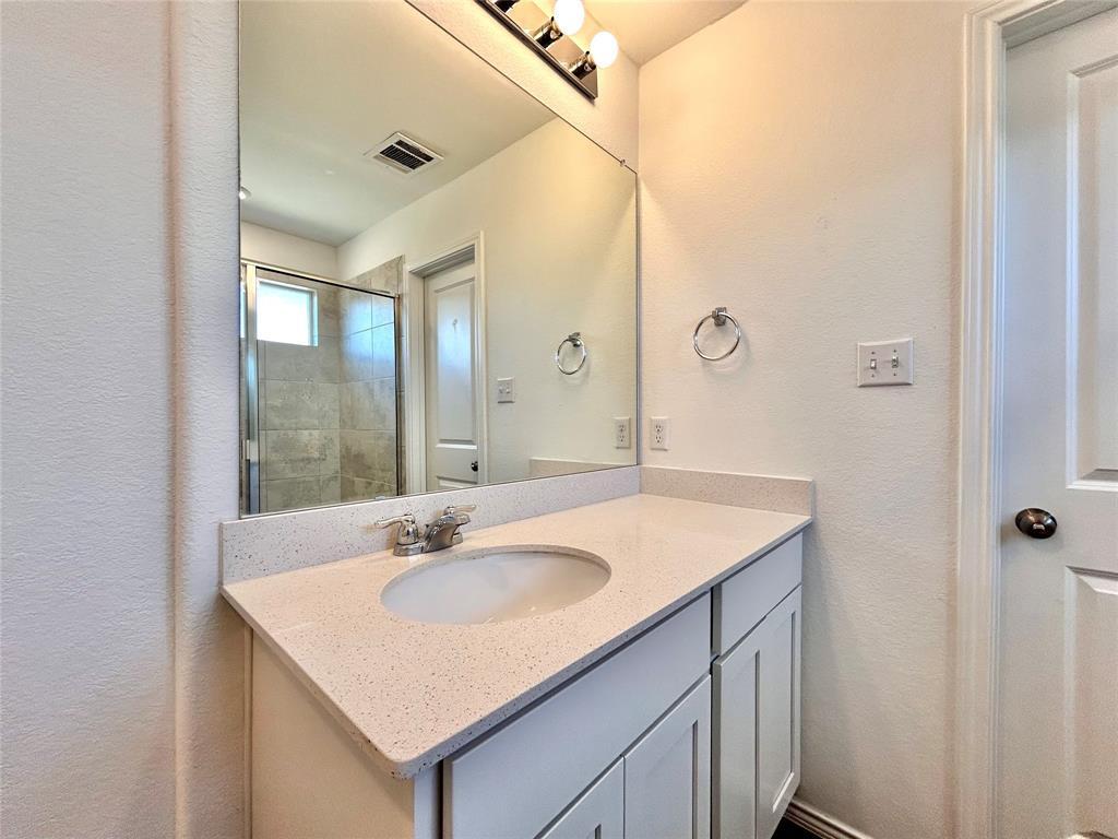 108 Joe Kidd Lane Jarrell, TX 76537 - Photo 11 of 22 a bathroom with a sink and a mirror