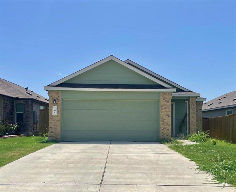 108 Joe Kidd Lane Jarrell, TX 76537 - Photo 2 of 22 a front view of a house with a yard and garage