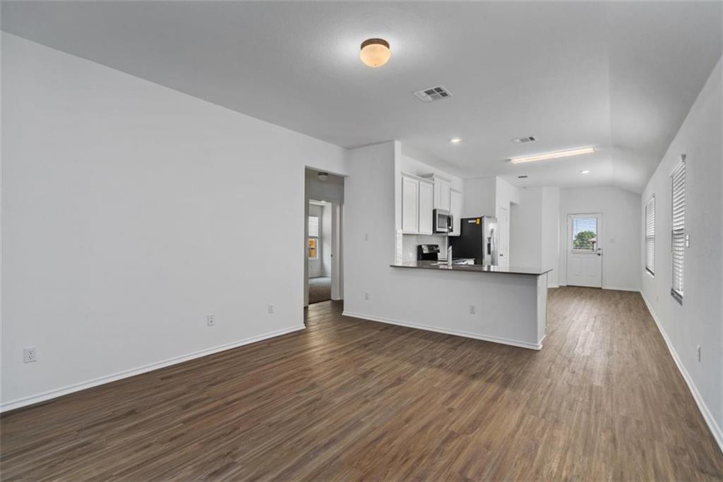 108 Joe Kidd Lane Jarrell, TX 76537 - Photo 6 of 22 a view of kitchen with cabinets and wooden floor