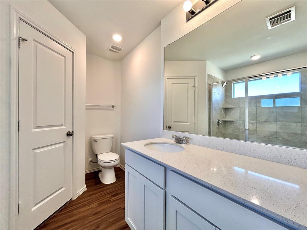 108 Joe Kidd Lane Jarrell, TX 76537 - Photo 10 of 22 a bathroom with a sink a toilet and a large mirror