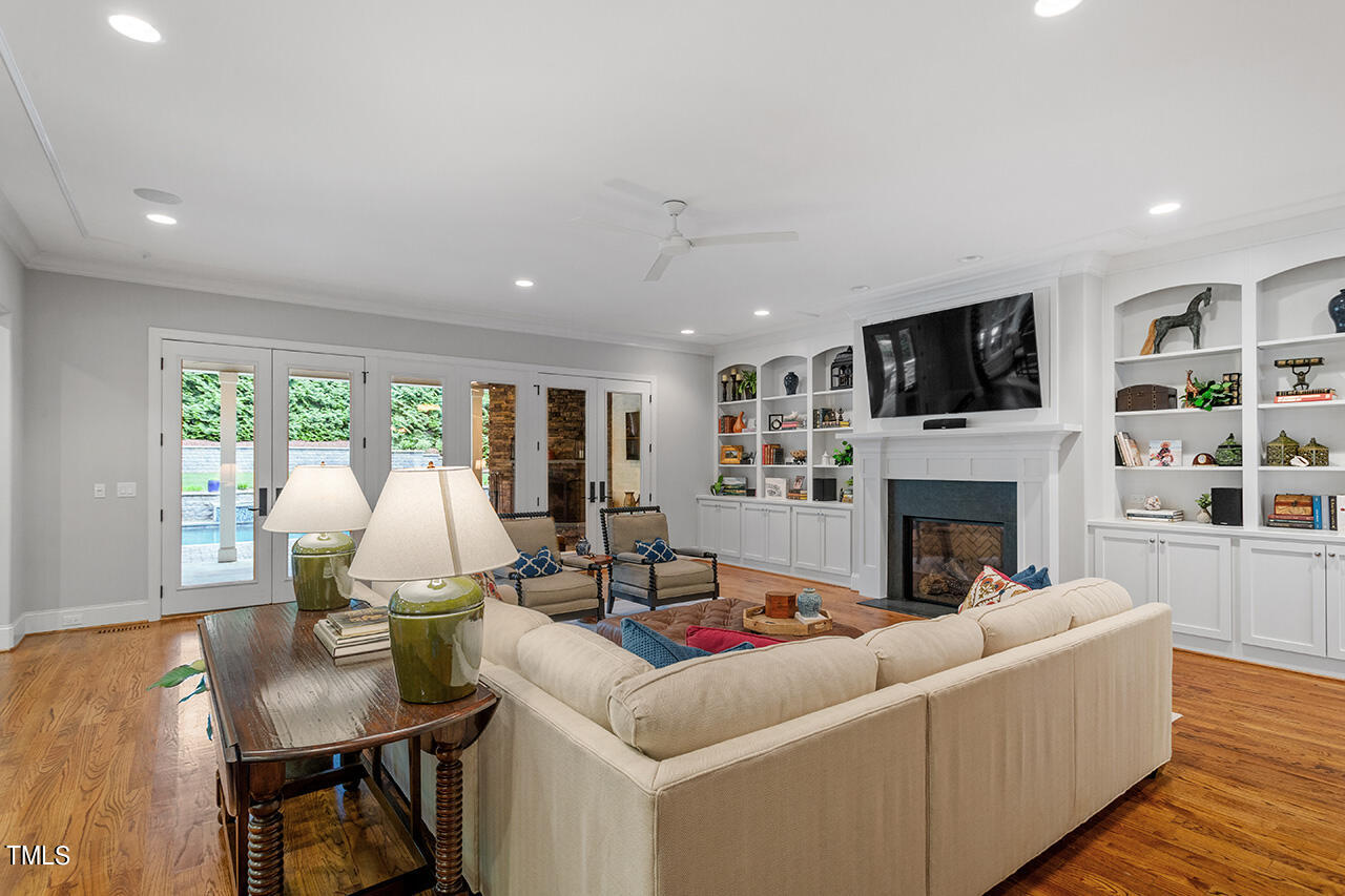 2311 Churchill Road Raleigh, NC 27608 - Photo 12 of 73 a living room with furniture a fireplace and a flat screen tv