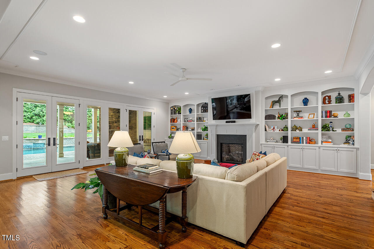 2311 Churchill Road Raleigh, NC 27608 - Photo 13 of 73 a living room with fireplace furniture and a wooden floor
