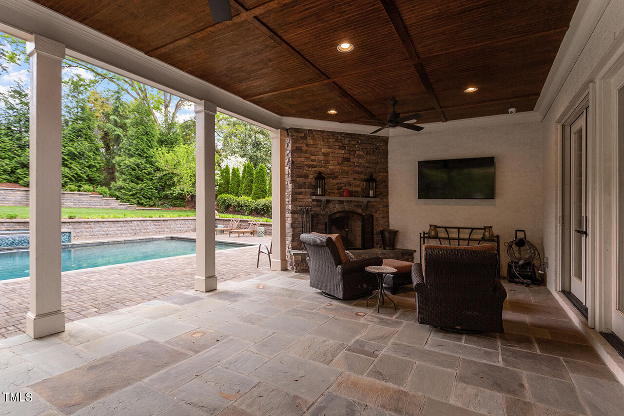 2311 Churchill Road Raleigh, NC 27608 - Photo 14 of 73 a living room with furniture a fireplace and a flat screen tv