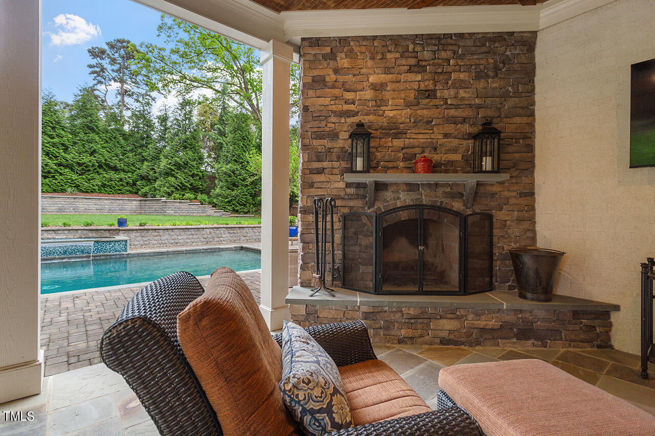 2311 Churchill Road Raleigh, NC 27608 - Photo 15 of 73 a living room with a fireplace and a floor to ceiling window