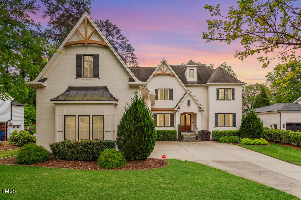 2311 Churchill Road Raleigh, NC 27608 - Photo 2 of 73 a front view of a house with a garden