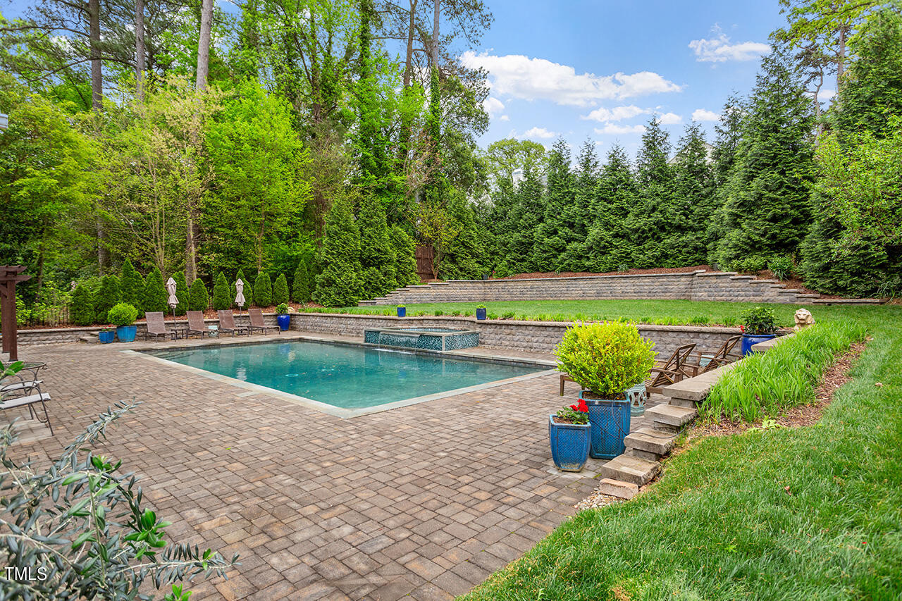 2311 Churchill Road Raleigh, NC 27608 - Photo 21 of 73 a view of a swimming pool with a sitting area