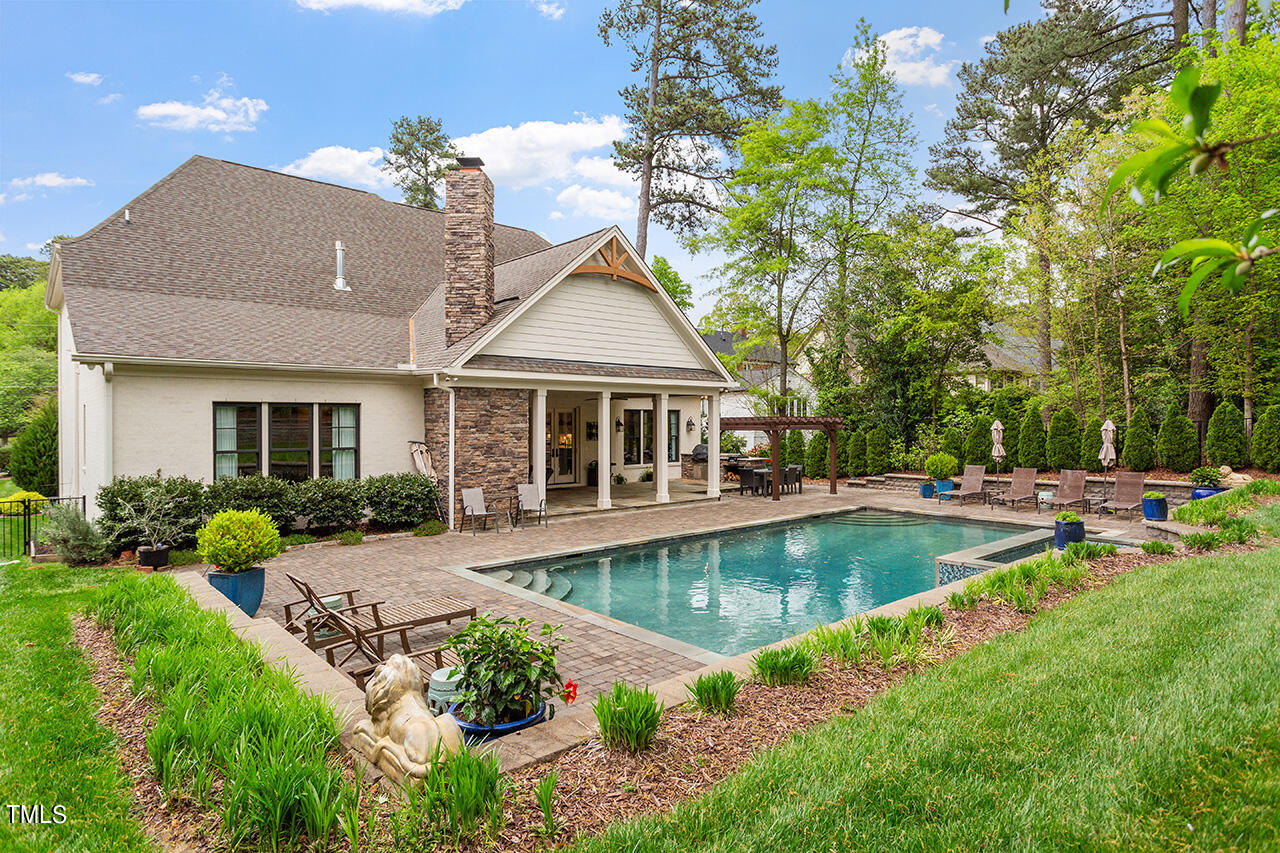 2311 Churchill Road Raleigh, NC 27608 - Photo 22 of 73 a view of a house with swimming pool and a garden