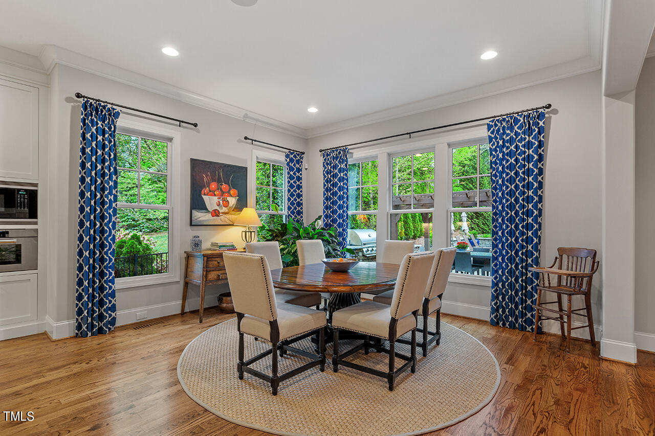 2311 Churchill Road Raleigh, NC 27608 - Photo 30 of 73 a dining room with furniture window and wooden floor