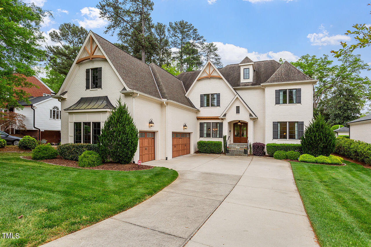 2311 Churchill Road Raleigh, NC 27608 - Photo 3 of 73 a front view of a house with a yard and trees