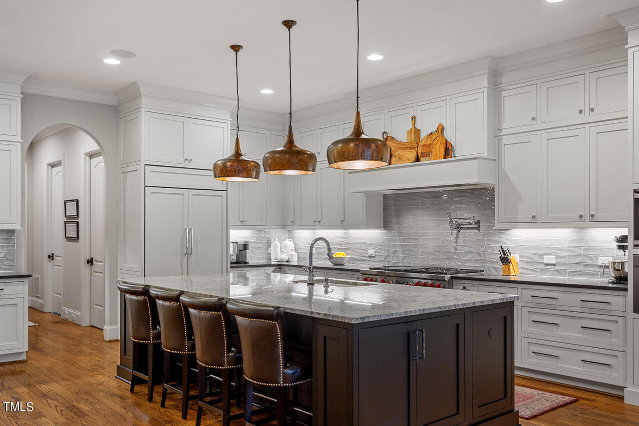 2311 Churchill Road Raleigh, NC 27608 - Photo 33 of 73 a kitchen with stainless steel appliances granite countertop a sink a stove and chairs