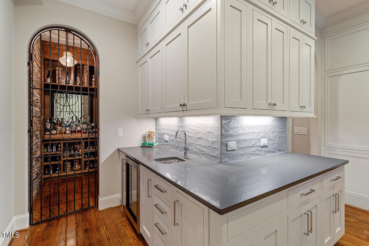 2311 Churchill Road Raleigh, NC 27608 - Photo 34 of 73 a kitchen with stainless steel appliances granite countertop a lot of counter space and wooden floors