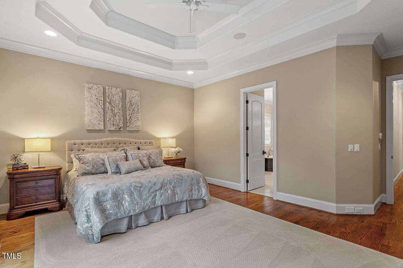 2311 Churchill Road Raleigh, NC 27608 - Photo 38 of 73 a bedroom with a large bed and a chandelier