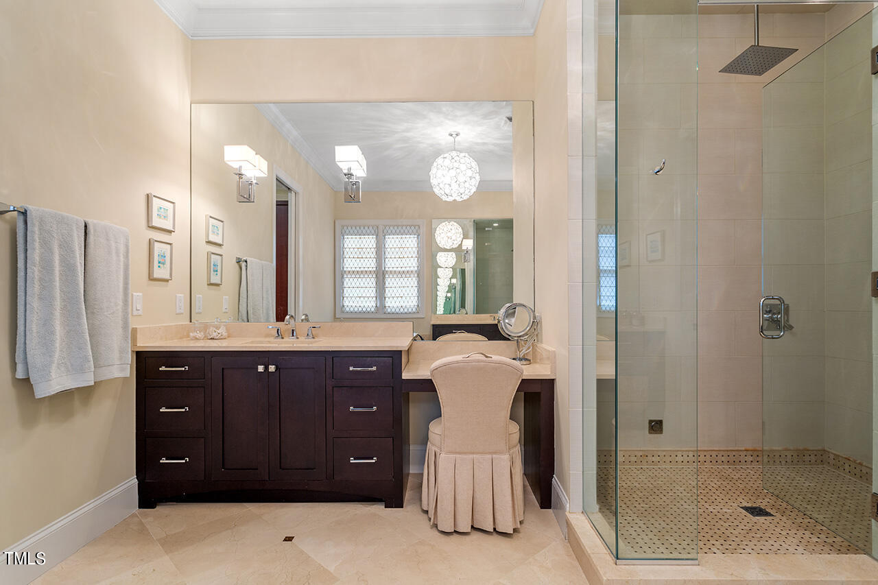 2311 Churchill Road Raleigh, NC 27608 - Photo 39 of 73 a spacious bathroom with a granite countertop sink a mirror and a shower