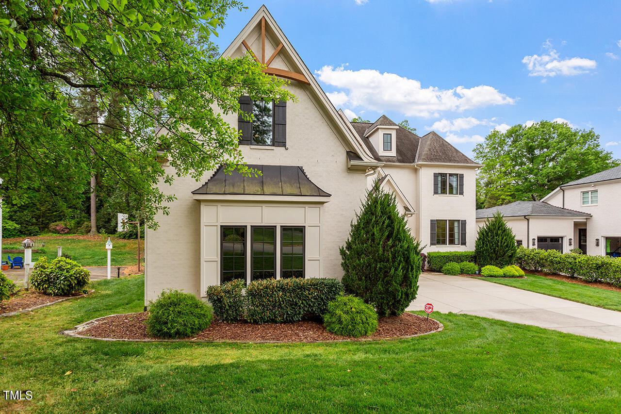2311 Churchill Road Raleigh, NC 27608 - Photo 4 of 73 a front view of a house with a yard and potted plants