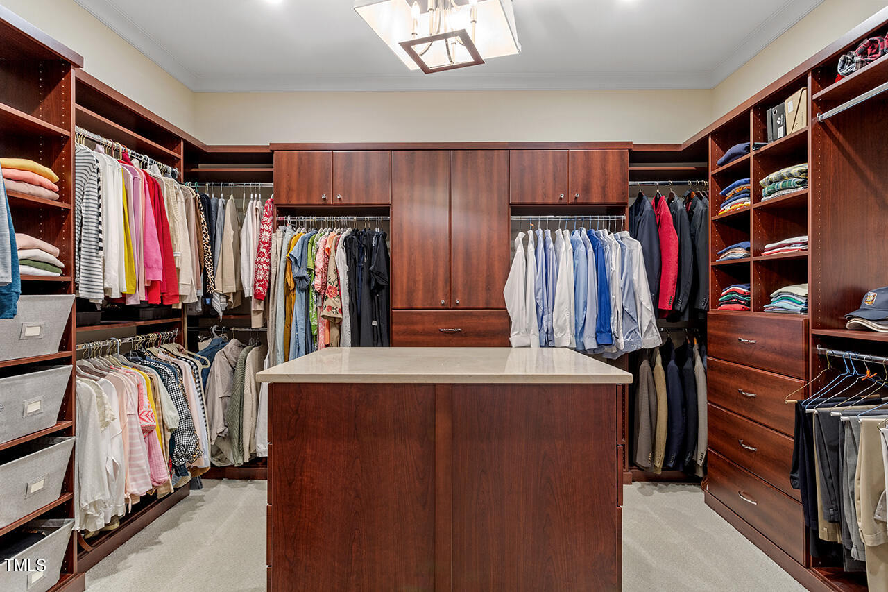 2311 Churchill Road Raleigh, NC 27608 - Photo 42 of 73 a view of walk in closet with clothes and shoes
