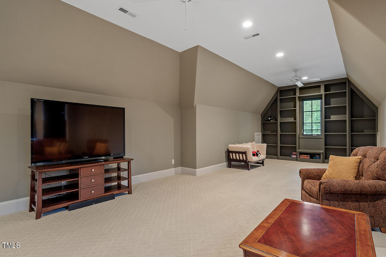 2311 Churchill Road Raleigh, NC 27608 - Photo 49 of 73 a living room with furniture and a flat screen tv
