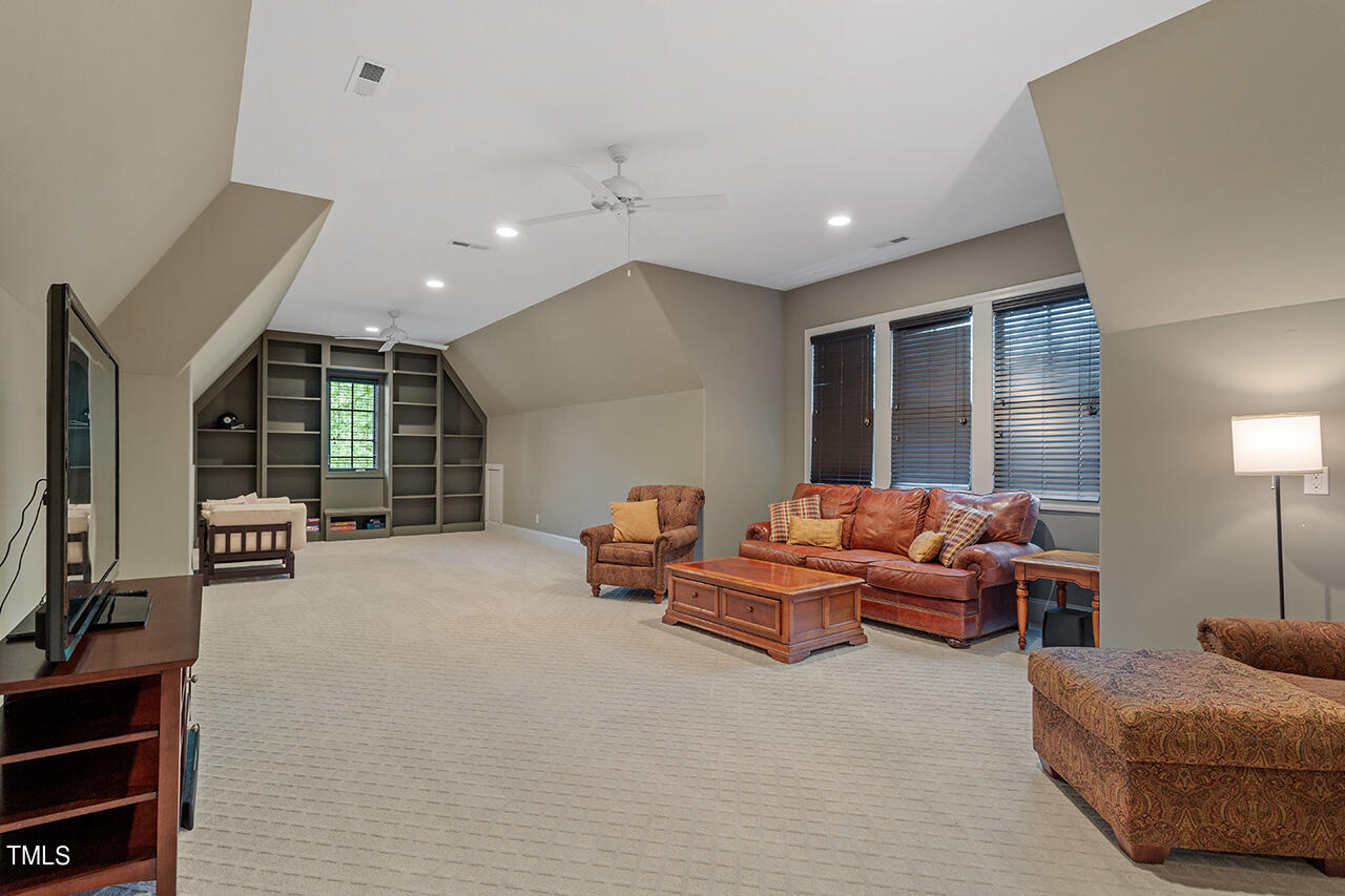 2311 Churchill Road Raleigh, NC 27608 - Photo 50 of 73 a living room with furniture and a flat screen tv