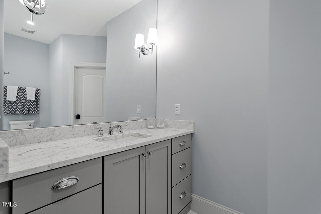 2311 Churchill Road Raleigh, NC 27608 - Photo 57 of 73 a bathroom with a sink and a mirror