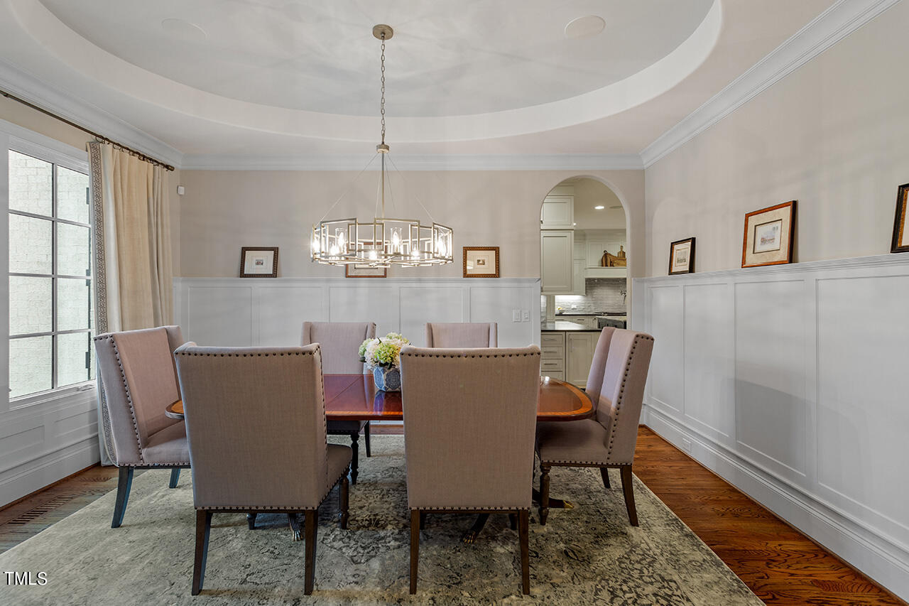 2311 Churchill Road Raleigh, NC 27608 - Photo 8 of 73 a view of a dining room with furniture a chandelier and wooden floor