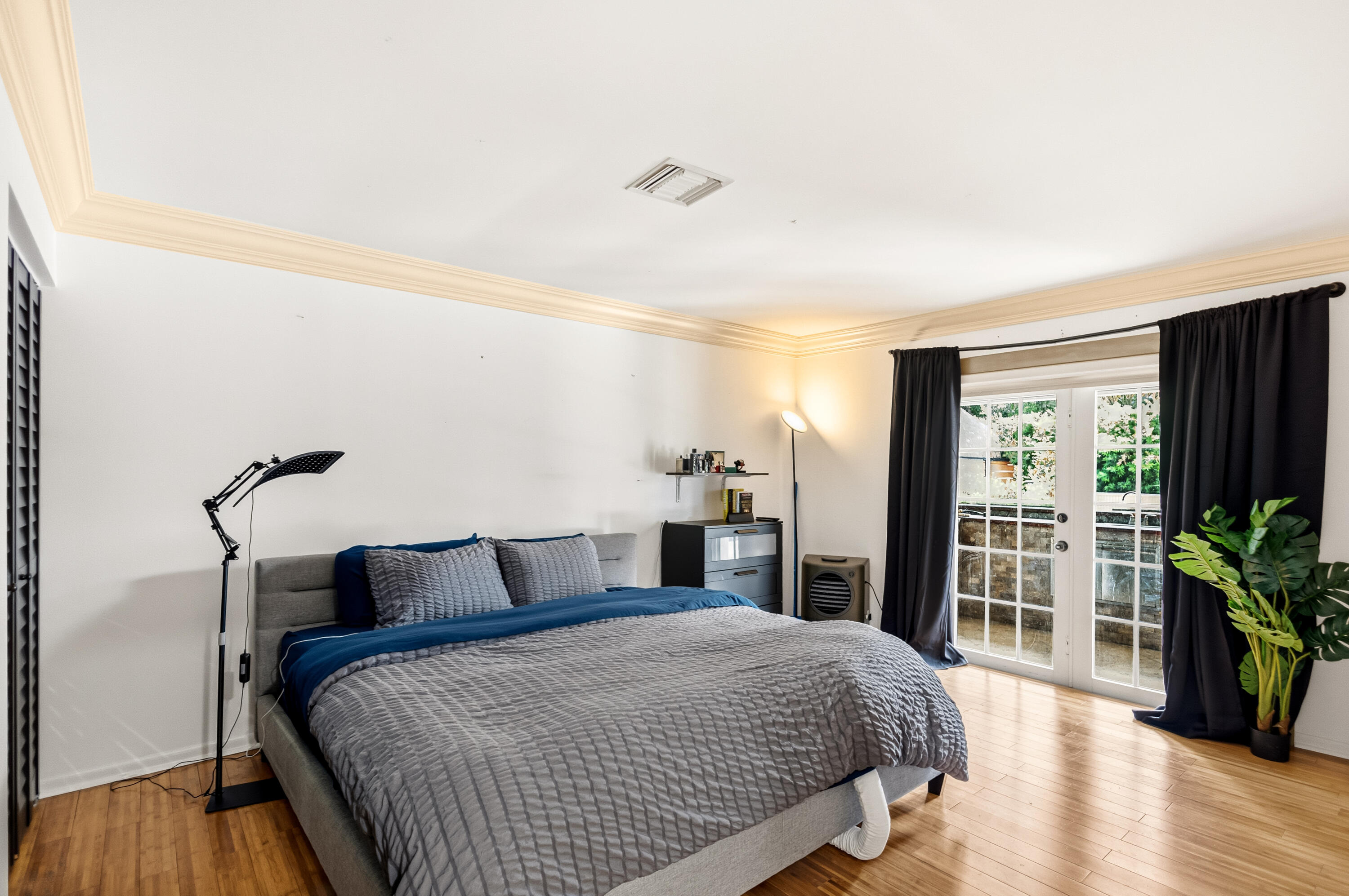 5223 Deerhurst Crescent Circle Boca Raton, FL 33486 - Photo 33 of 51 a bedroom with bed and wooden floor