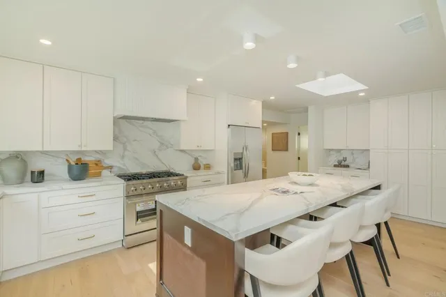 a kitchen with a stove a sink and a refrigerator