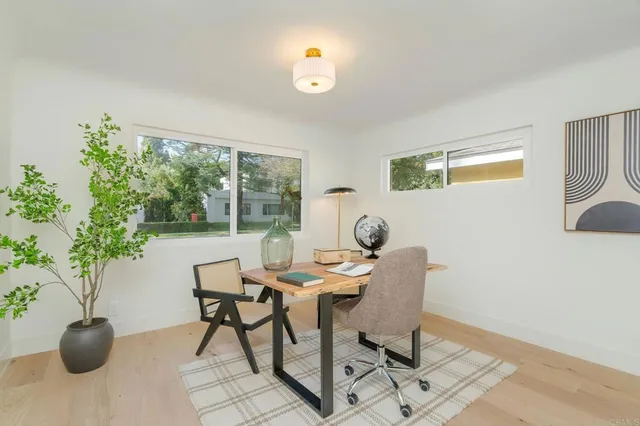 a dining room with furniture and potted plants