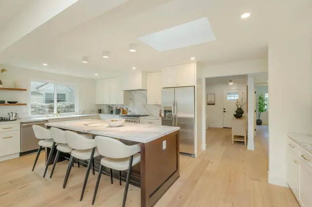 a large kitchen with a table and chairs