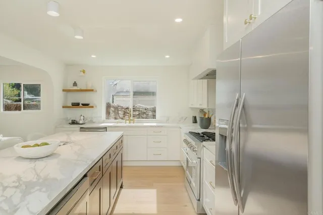 a kitchen with a sink stove and refrigerator