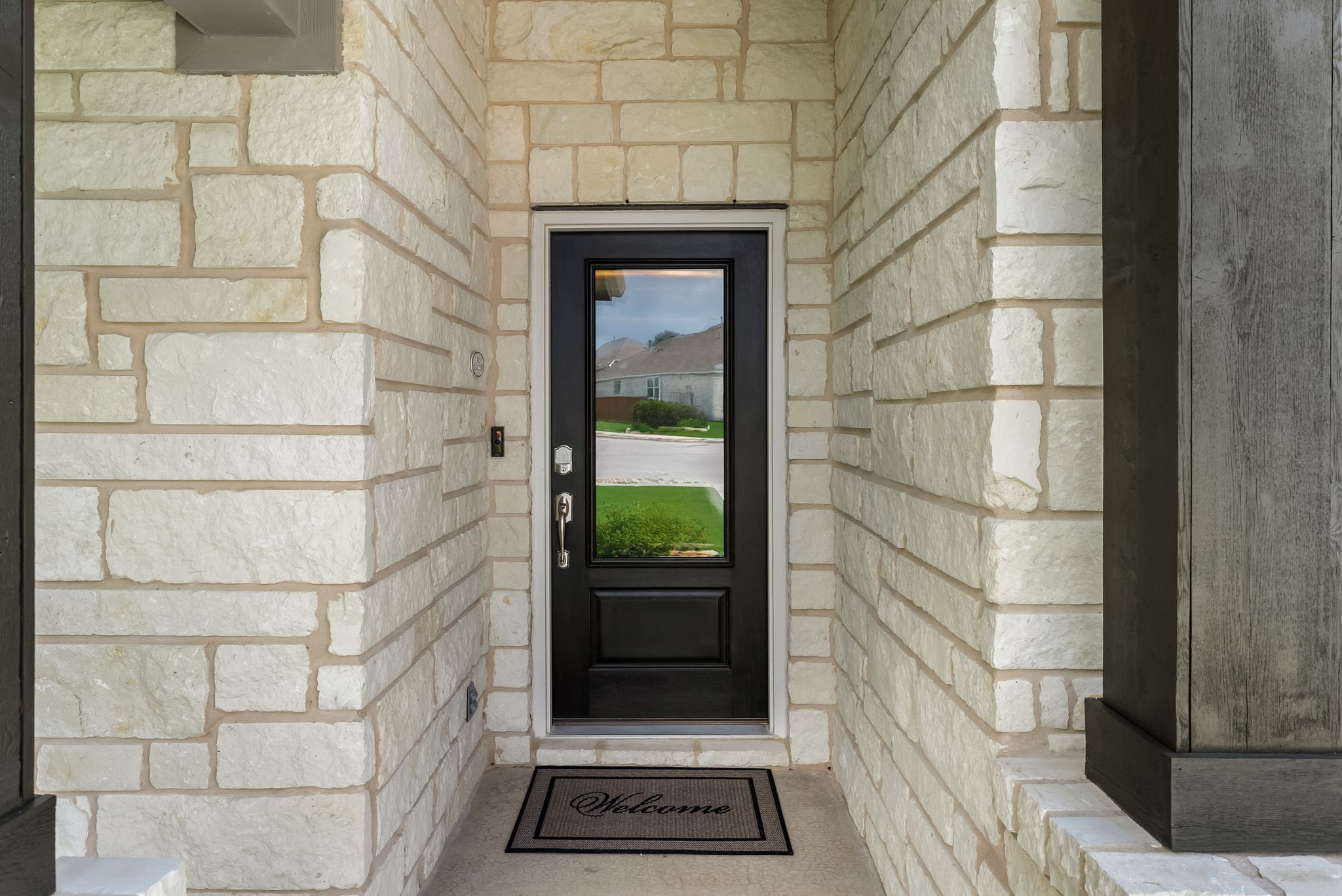 300 Prato Place Georgetown, TX 78628 - Photo 5 of 40 A dark, inviting entry door beckons guests, framed by a charming stone facade.